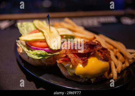 Crispy bacon cheese burger and fries Stock Photo