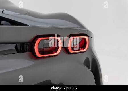 Right taillights of a Ferrari SF90 Supercar on white background Stock Photo