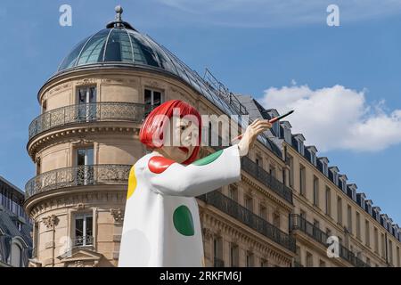 Luxury shopping. Huge sculpture in the likeness of Japanese artist Yayoi Kusama pointing at Louis Vuitton store with the paintbrush, Paris, France, EU Stock Photo