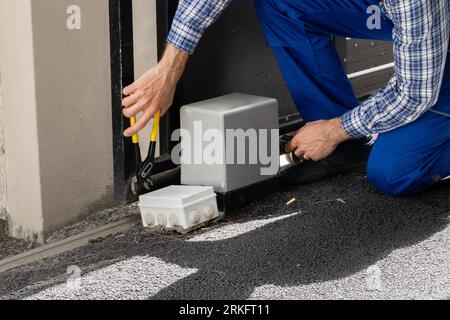 Repairman Fixing Broken Automatic Door In Building Stock Photo