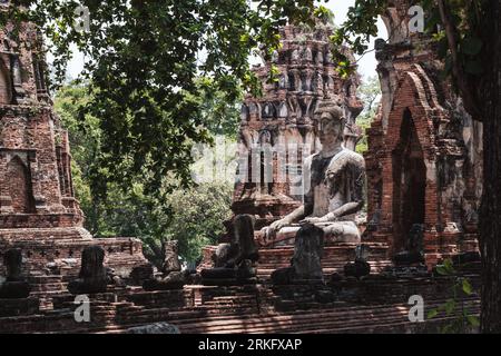The Ruins of Buddha statues and pagoda in Wat Mahathat, the old Thai temple, Thailand. Stock Photo