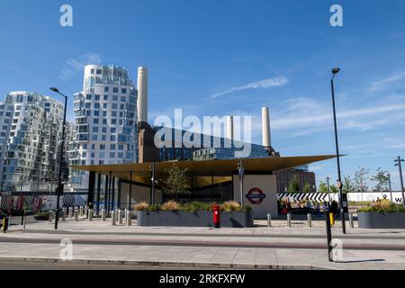 Battersea Power Station tube station with Prospect Place chimneys of Battersea Power Station in the background. The tube station is part of a major re Stock Photo