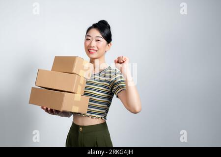 Young woman at online shop screaming proud, celebrating victory and success very excited with raised arms Stock Photo