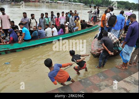 The traditional Sylhet's historic 'Keane Bridge over the Surma River in Sylhet has become vulnerable, with vehicular and human traffic is closed for renovation work. In order to preserve this heritage structure built during the British period, the bridge division of the Eastern Railway has begun renovation work. Apart from using two other bridges in the city, people also cross the Surma River by boats in Kinbridge Chandnighat area. Sylhet, Bangladesh. Stock Photo