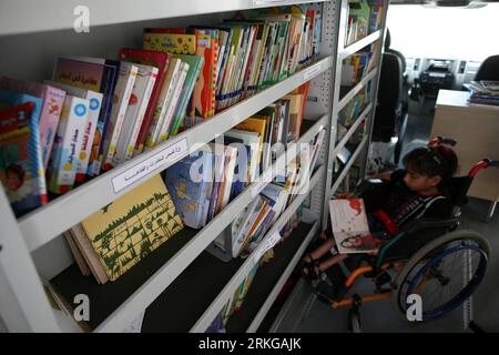 Bildnummer: 55572039  Datum: 05.07.2011  Copyright: imago/Xinhua (110705) -- GAZA, July 5, 2011 (Xinhua) -- A disabled Palestinian young girl reads book at a mobile library in Gaza City, July 5, 2011. The mobile library project is funded by the German-French Cultural Center which contains more than 1500 books and aiming to allow the children access to books and improve their reading skills. (Xinhua/Wissam Nassar) (jl) MIDEAST-GAZA-MOBILE LIBRARY PUBLICATIONxNOTxINxCHN Gesellschaft Bildung Buch Büchermobil mobile Bibliothek Kinder x0x xst lesen Palästina Israel 2011 quer     Bildnummer 55572039 Stock Photo