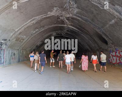 Tour group explore an old secret underground bunker used by Yugoslav