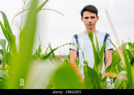 young guy farmer stands in a cornfield Stock Photo