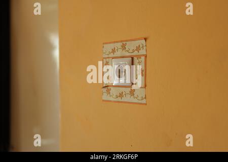 A closeup of a vibrant ornament Socket on a wall under the natural light Stock Photo