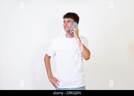 Happy caucasian young man using smart phone cellphone for calls, social media, mobile application online isolated in white background. Stock Photo