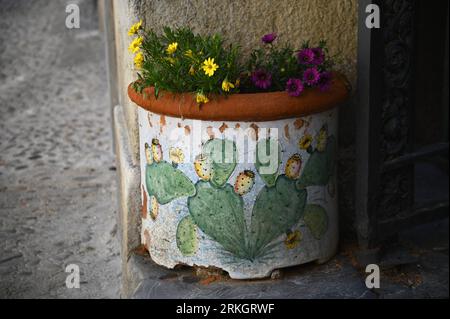 Traditional Sicilian Majolica glazed pottery planter on Via Bordonaro in Cefalù Sicily, Italy. Stock Photo