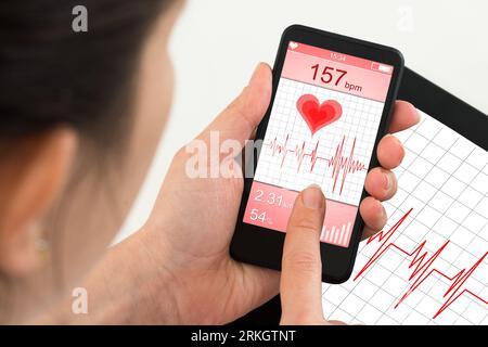 Close-up Of Doctor Holding Mobile Phone With App For Health Stock Photo