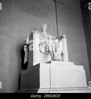 1960s, historica, large marble statue of Abraham Lincoln, the 16th U.S President, inside the Lincoln Memorial in Washington DC, USA. Above the statue an inscription about the memory of Lincoln in saving the Union. Stock Photo