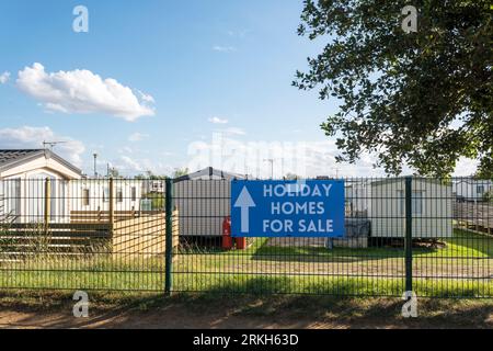 Holiday Homes For Sale sign at a caravan park on the Norfolk coast. Stock Photo