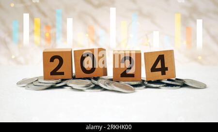 Financial coins stacked wooden cubes 2024 on white background. Business, Risk Management, Insurance, Resolution, strategy, solution, goal, New Year Ne Stock Photo