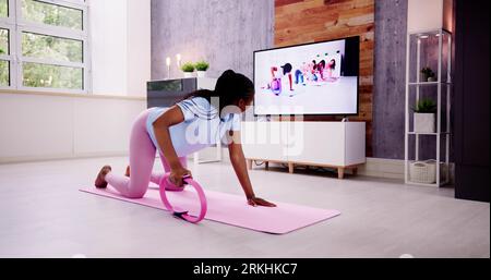 Pregnant Woman In Online Fitness Exercise Class Stock Photo