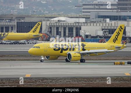 Los Angeles, California / USA - Aug. 21, 2023: A yellow Airbus A320 commercial airliner jet, operated by Spirit Airlines, is shown taxiing at LAX. Stock Photo
