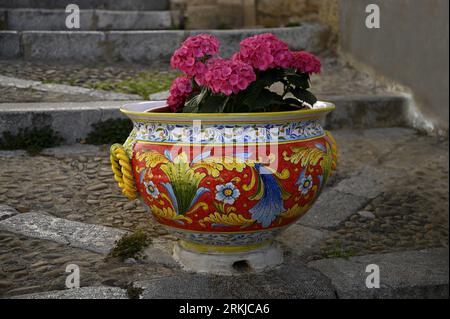 Traditional Sicilian Majolica glazed pottery planter on Via Bordonaro in Cefalù Sicily, Italy. Stock Photo