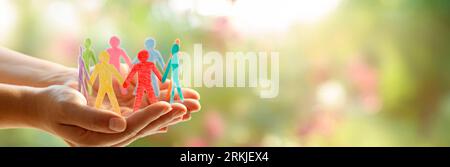 Diversity Inclusion And Equality Concept - Paper People Silhouettes On Hands Stock Photo