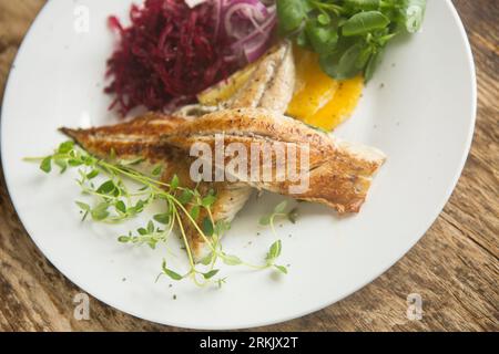 Fresh, fried mackerel fillets, Scomber scombrus, caught in the English Channel served with a salad of beetroot, orange, red onion, watercress and fres Stock Photo