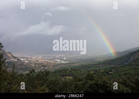 View from the viewpoint of the Red Fountain on a rainy day with rainbows over Alcoy, Spain Stock Photo