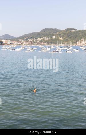 Man walking in the ocean, San Sebastian, Spain Stock Photo