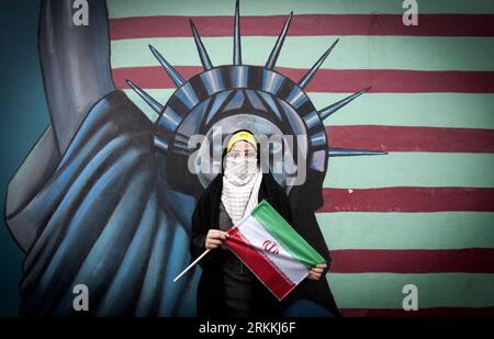 111104 -- TEHRAN, Nov. 4, 2011 Xinhua -- A student holds an Iran flag during a rally marking the 32nd anniversary of the seizure of the U.S. Embassy in downtown Tehran, Iran, Nov. 4, 2011. Iranians on Friday marked the anniversary of the seizure of the U.S. embassy in Tehran by Iranian students 32 years ago. The United States cut diplomatic relations with Iran on April 7, 1980, after a group of Iranian students seized the U.S. embassy in Tehran and captured some 60 U.S. diplomats in 1979. In the hostage crisis, 52 of the U.S. diplomats were held in captivity for 444 days.Xinhua/Ahmad Halabisaz Stock Photo