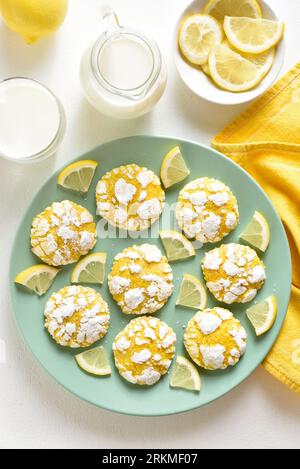 Homemade lemon crinkle cookies on plate over white background. Top view, flat lay Stock Photo