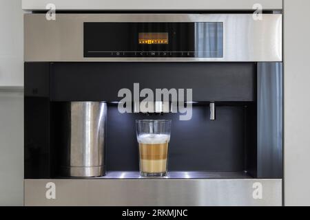 Built-in fully automatic coffee machine in kitchen furniture Stock Photo