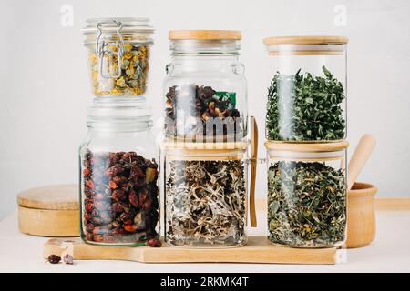 Dry medicinal herbal tea, various ingredients in jars. Stock Photo