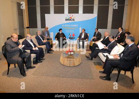 Johannesburg, Gauteng, South Africa. 24th Aug, 2023. Iranian President Ebrahim Raisi (L) meets with Chinese President Xi Jinping (R) as part of the 15th BRICS Summit. (Credit Image: © Iranian Presidency via ZUMA Press Wire) EDITORIAL USAGE ONLY! Not for Commercial USAGE! Stock Photo