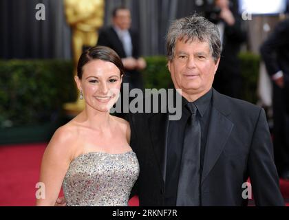 (120226) -- HOLLYWOOD, Feb. 26, 2012 (Xinhua) -- Nominee for Best Art Direction, Robert Gould (R) of the film The Artist arrives on the red carpet for the 84th Annual Academy Awards at the Kodak Theater in Hollywood, California, the United States, Feb. 26, 2012. (Xinhua/Yang Lei) US-HOLLYWOOD-OSCARS-RED CARPET PUBLICATIONxNOTxINxCHN   Hollywood Feb 26 2012 XINHUA Nominee for Best Art Direction Robert Gould r of The Film The Artist arrives ON The Red Carpet for The 84th Annual Academy Awards AT The Kodak Theatre in Hollywood California The United States Feb 26 2012 XINHUA Yang Lei U.S. Hollywoo Stock Photo