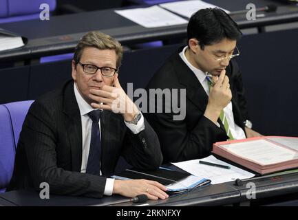 120227 -- BERLIN, Feb. 27, 2012 Xinhua -- German Foreign Minister Guido Westerwelle L and German Economy Minister and vice-chancellor Philipp Roesler take part in the parliamentary vote on financial aid for Greece at the Bundestag lower house in Berlin, capital of Germany, February 27, 2012.Xinhua/Ma Ningyy GERMANY-BERLIN-MERKEL-PARLIAMENT VOTE-GREECE PUBLICATIONxNOTxINxCHN Stock Photo