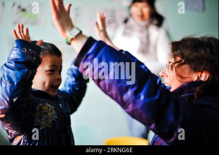 Bildnummer: 57119976  Datum: 26.02.2012  Copyright: imago/Xinhua (120228) -- CHANGSHA, Feb. 28, 2012 (Xinhua) -- Dorothee Brutzer (R) gives language training for a disabled boy at a rehabilitation training center in Changsha, capital of central China s Hunan Province, Feb. 8, 2012. Bach s Bakery is located in the Xiangchun Lane of Changsha. The little bakery with exquisite decoration is well-known in nearby areas for its 41-year-old foreign owner and deaf-mute employees here. The owner Uwe Brutzer and his wife Dorothee Brutzer, who came from Stuttgart of Germany, have lived in Changsha for ten Stock Photo