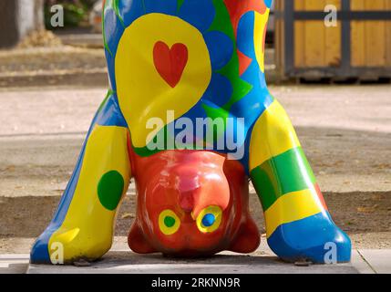 colourful bear doing a headstand, Artwork Buddy Baer in front of the Kurpark, Germany, North Rhine-Westphalia, Bad Pyrmont Stock Photo