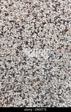 Exterior marble chips. Texture of crushed stone. Background of construction work and finishing from natural building materials. Stock Photo