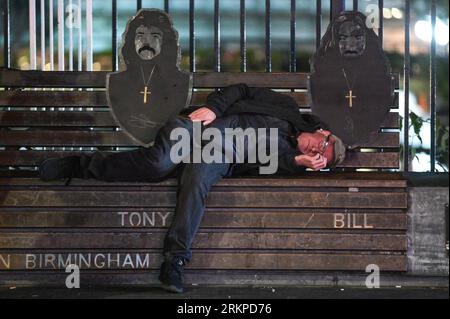 Broad Street, Birmingham, 25th August 2023 - A man has a nap on Birmingham's Black Sabbath Bridge on Broad Street - Revellers descended onto Birmingham's Broad Street on Friday evening to enjoy the last Bank Holiday weekend until Christmas. Most partygoers wore skimpy clothes despite temperatures dropping compared to earlier in the week. Large queues formed outside nightclubs including PRYZM, Rosies and Popworld. Groups of friends posed for a photo as the partied the night away. Credit: Stop Press Media/Alamy Live News Stock Photo