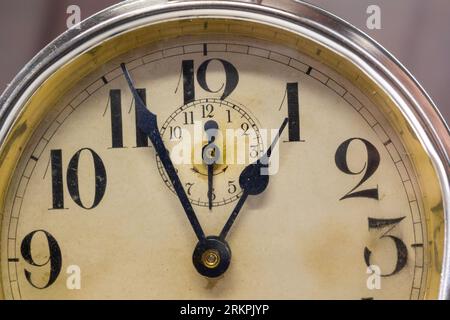 Vintage Alarm clock close-up focus on hands pointing at one and six Stock Photo