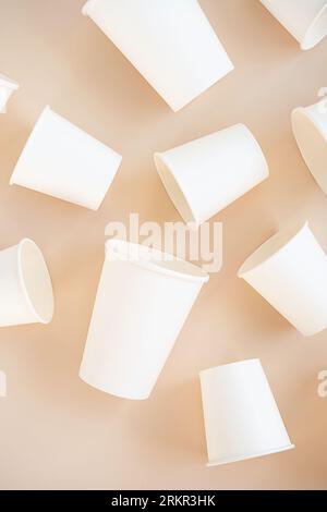 Cardboard cups for coffee or tea flat lay on neutral background. Stock Photo