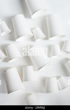 Paper coffee cups different sizes layout, monochrome image. Stock Photo