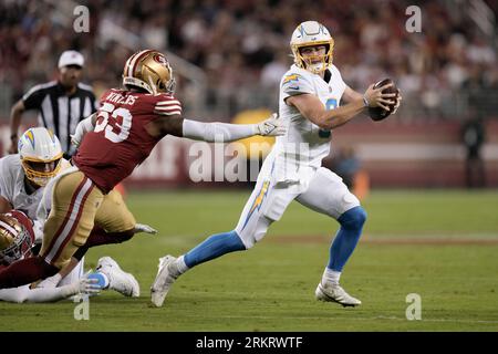 Los Angeles Chargers quarterback Max Duggan, right, gets away from San  Francisco 49ers linebacker Dee Winters during the second half of an NFL  preseason football game Friday, Aug. 25, 2023, in Santa