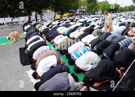 Shiite Muslims pray during a procession to mark Ashoura in Karachi ...