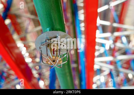 Fire sprinkler in a large warehouse with metal shelving Stock Photo