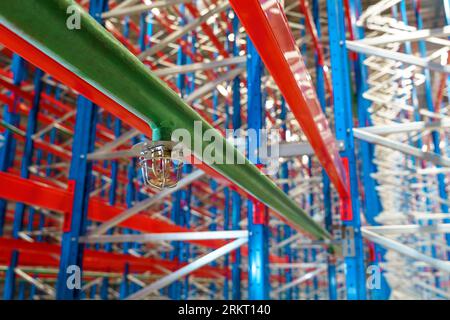 Fire sprinkler in a large warehouse with metal shelving Stock Photo