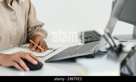 Developer programmer use mouse and checking code on laptop while programming to developing website. Stock Photo
