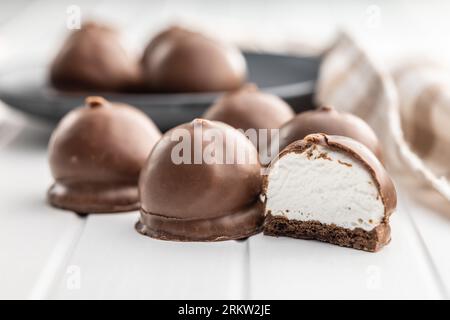Chocolate covered marshmallows. Sweet dessert on the white table. Stock Photo