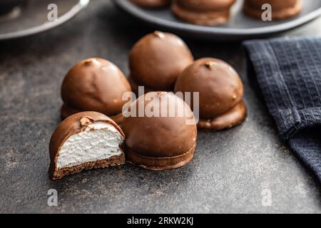 Chocolate covered marshmallows. Sweet dessert on the black table. Stock Photo
