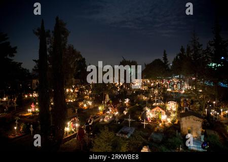 (121101) -- MEXICO CITY, Nov. 1, 2012 (Xinhua) -- Residents stay near to their relatives graves, during the Day of the Dead celebrations at the San Gregorio Burough Graveyard, in Xochimilco, Mexico City, capital of Mexico, on Nov. 1, 2012. The Day of the Dead is a Mexican celebration that has a prehispanic origin that honors the deceased adults on Nov. 2 and the deceased children on Nov. 1, this celebration matches with the catholic holidays of the Day of the Faithful Deceased and the Day of All the Saints. (Xinhua/Pedro Mera)(zyw) MEXICO-MEXICO CITY-SOCIETY-DAY OF THE DEAD PUBLICATIONxNOTxINx Stock Photo