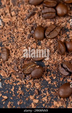 Roasted coffee beans lie together with chocolate crumbled into small pieces, fragrant coffee together with chocolate crumbs Stock Photo