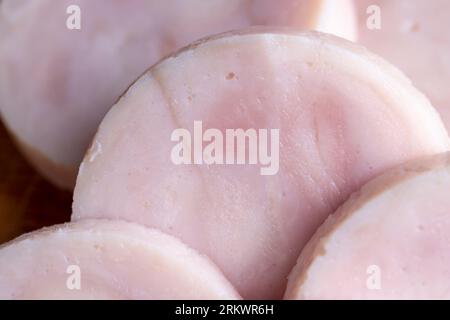 Sliced round-shaped ham from chicken meat, freshly sliced chicken ham in the kitchen Stock Photo