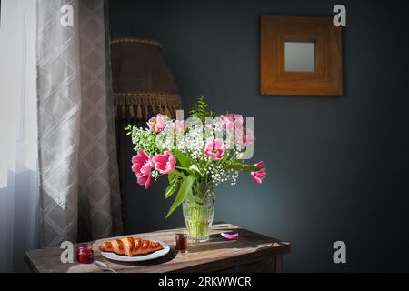 Breakfast with tulips and coffee on the table Stock Photo